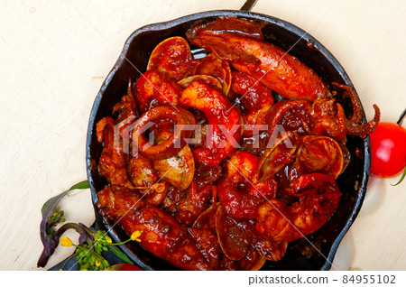 fresh seafoos stew on an iron skillet 84955102