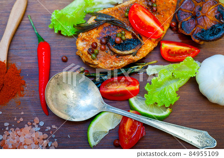 wood fired hoven cooked chicken breast on wood board 84955109