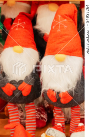 Blurred picture of soft toy gnomes on the counter of the store. A toy shop. Christmas shopping. Defocused background image Blurred picture of soft toy gnomes on the counter of the store. A toy shop. Christmas shopping. Defocused background image 84955264