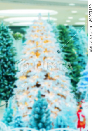Defocused image of various Christmas trees at the Christmas tree market. Blurred background picture Defocused image of various Christmas trees at the Christmas tree market. Blurred background picture 84955389