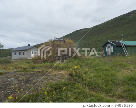 Sami village Staloluokta at Virihaure lake with houses and cottage, mountains and birch trees. summer moody and foggy day at Padjelantaleden hiking trail. Sweden Lapland landscape Sami village Staloluokta at Virihaure lake with houses and cottage, mountains and birch trees. summer moody and foggy day at Padjelantaleden hiking trail. Sweden Lapland landscape 84956180