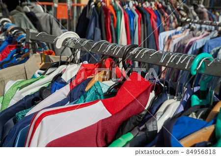 Selling used clothes at a market 84956818