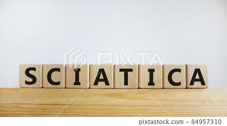 Sciatica symbol. Wooden cubes with word 'sciatica'. Beautiful white background. Medical and sciatica concept. Copy space. Sciatica symbol. Wooden cubes with word 'sciatica'. Beautiful white background. Medical and sciatica concept. Copy space. 84957310