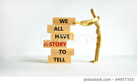 We all have a story to tell symbol. Wooden blocks with words 'We all have a story to tell'. Businessman model. Beautiful white background. Business, popular quotation concept. Copy space. We all have a story to tell symbol. Wooden blocks with words 'We all have a story to tell'. Businessman model. Beautiful white background. Business, popular quotation concept. Copy space. 84957358