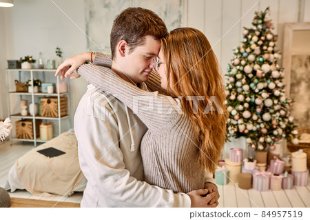 Romantic date of young couple in love on Christmas Eve. 84957519