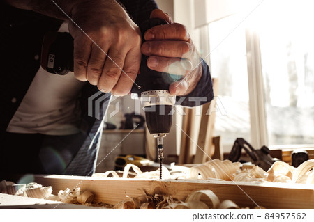 Close up of a carpenter drilling a hole in timber Close up of a carpenter drilling a hole in timber 84957562