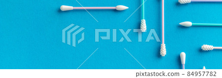 Flat lay top view reusable silicone swab on blue background. Alternative to cotton buds 84957782