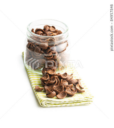 Sweet chocolate breakfast cereal flakes in jar. 84957846