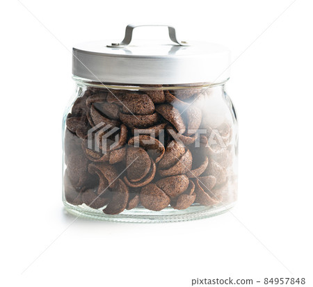 Sweet chocolate breakfast cereal flakes in jar. 84957848