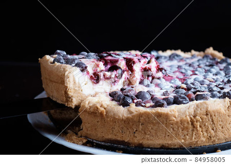 Berry pie cake from the cherries currants in a bowl of fresh steam a whole and slices of hot background blurred Berry pie cake from the cherries currants in a bowl of fresh steam a whole and slices of hot background blurred 84958005