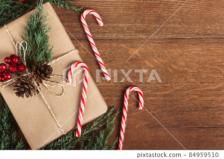 Gift box with winter decor on wooden table. Gift box with winter decor on wooden table. 84959510