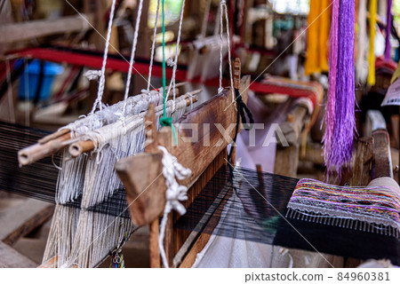 Traditional woven fabric Mae Chaem pattern that has not finished weaving in the loom at Mae Chaem District, Chiang Mai Province, Thailand Traditional woven fabric Mae Chaem pattern that has not finished weaving in the loom at Mae Chaem District, Chiang Mai Province, Thailand 84960381