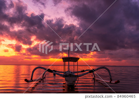 Beautiful sunrise scenery with Jukung is traditional balinese fishing boats at Karang Beach, Sanur, Bali, Indonesia. 84960465
