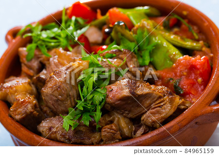 Cooked gyuvech dish of bulgarian cuisine of beef with vegetables at clay pot Cooked gyuvech dish of bulgarian cuisine of beef with vegetables at clay pot 84965159