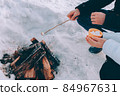 couple roast marshmallow over campfire. winter theme 84967631
