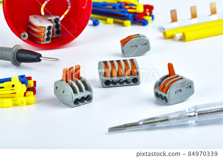 Electrical accessories, screwdriver, clamps, ties on a white background. Electrical accessories, screwdriver, clamps, ties on a white background. 84970339
