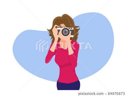 A blonde woman stands with a camera, happily photographing landscapes, and people. flat style cartoon vector illustration 84970873