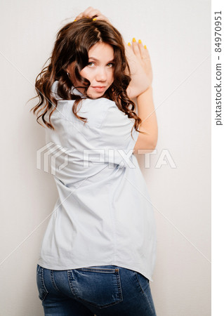 pregnant woman in jeans and a shirt. women's health. view from the back 84970951