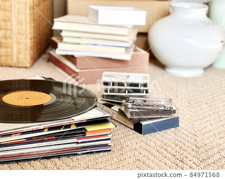 Stacked record jackets, vinyl records, books, jars, etc. 84971568