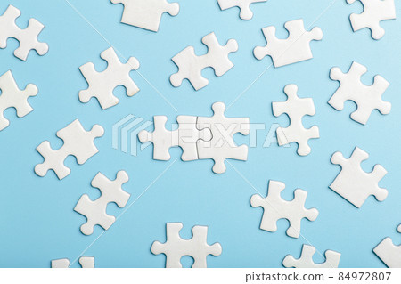 Puzzle pieces are connected. White puzzle pieces on a blue background. Business, partner, solution, alliance, union concept. Puzzle pieces are connected. White puzzle pieces on a blue background. Business, partner, solution, alliance, union concept. 84972807