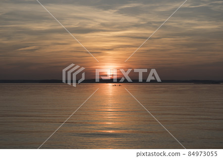 Sunset on the lake. Wonderful summer colorful sunset with clouds on a forest lake in warm summer weather Sunset on the lake. Wonderful summer colorful sunset with clouds on a forest lake in warm summer weather 84973055