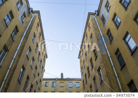 Courtyards of St. Petersburg. Old historic courtyards of St. Petersburg. Typical and classic urban architecture of residential buildings. 84973074