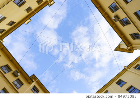 Courtyards of St. Petersburg. Old historic courtyards of St. Petersburg. Typical and classic urban architecture of residential buildings. Courtyards of St. Petersburg. Old historic courtyards of St. Petersburg. Typical and classic urban architecture of residential buildings. 84973085