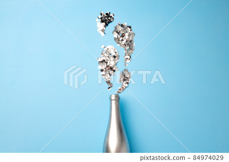 Festive background with champagne bottle and confetti Festive background with champagne bottle and confetti 84974029