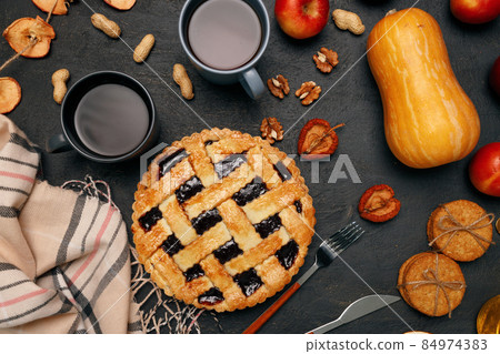 Thanksgiving pie and pumpkin on black background Thanksgiving pie and pumpkin on black background 84974383