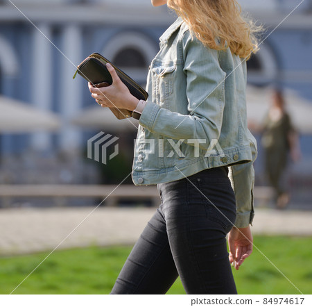 a young girl is smoking on the street a young girl is smoking on the street 84974617