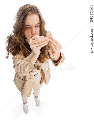 Close-up portrait of smiling young girl, dressmaker posing isolated on white background. Concept of job, hobby Close-up portrait of smiling young girl, dressmaker posing isolated on white background. Concept of job, hobby 84975163