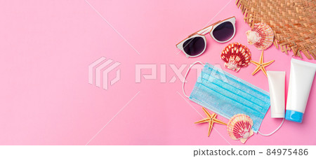 Medical mask with sunscreen cream on pink background. Coronavirus summer concept 84975486