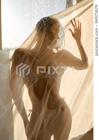 Sensual woman prefect body showering behind curtains Sensual woman prefect body showering behind curtains 84975676