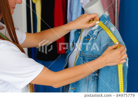 Close up photo of a seamstress at work Close up photo of a seamstress at work 84975779