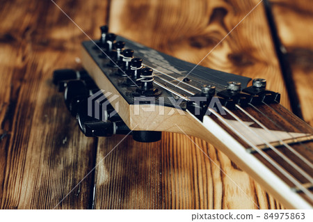 Guitar headstock with tuners on dark background Guitar headstock with tuners on dark background 84975863