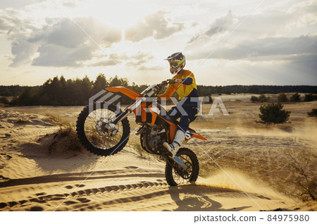 Skilled moto rider making stunt on motorbike 84975980