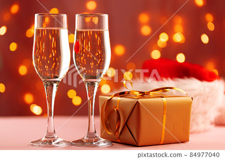 Christmas and New Year concept with two glasses of champagne against bokeh lights 84977040