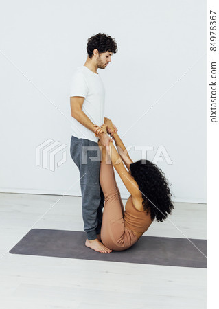 man and woman engaged in yoga asana gymnastics 84978367