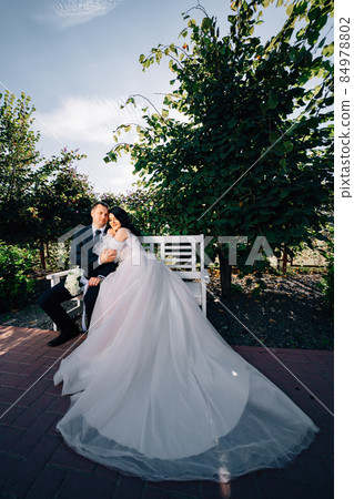 happy newlyweds on a park bench. 84978802