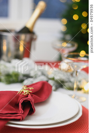 Christmas table setting, red towel with gold ring. Family holiday dinner or New Year party. Christmas table setting, red towel with gold ring. Family holiday dinner or New Year party. 84979936