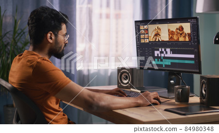 Unrecognizable guy editing astronaut video Unrecognizable guy editing astronaut video 84980348