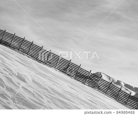 Snowy ski track prepared by snowcat with trace from skis and snowboards Snowy ski track prepared by snowcat with trace from skis and snowboards 84980488