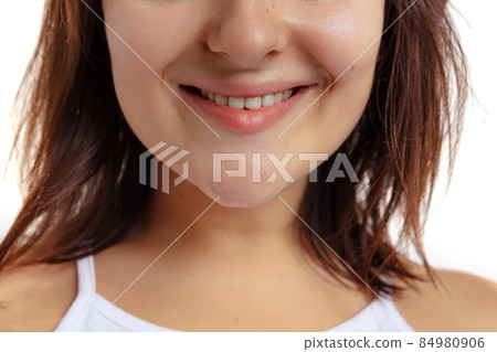 Close-up of open smiling female mouth without lips makeup. Cosmetology, medicine, dental health. Detailed. 84980906