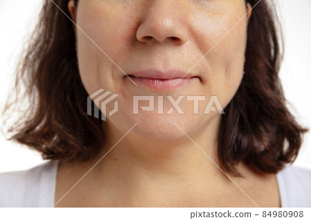 Close-up of female mouth with closed lips without makeup. Anti-aged cosmetology, medicine, dental health. Detailed. Close-up of female mouth with closed lips without makeup. Anti-aged cosmetology, medicine, dental health. Detailed. 84980908