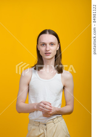 Androgyn young man in men outfit indoors. Studio shot Androgyn young man in men outfit indoors. Studio shot 84981122