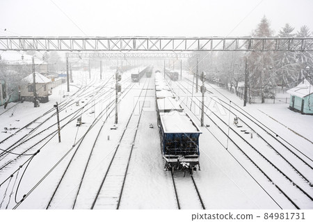 Train station with railways covered by snow in winter time Train station with railways covered by snow in winter time 84981731