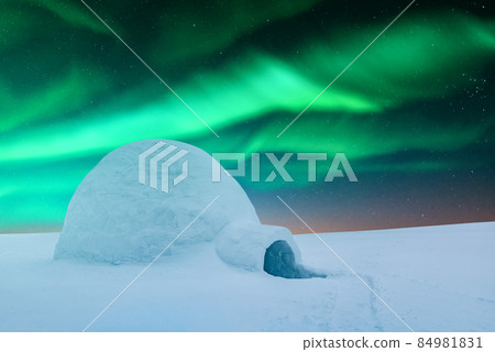 Wintry scene with glowing polar lights and snowy igloo Wintry scene with glowing polar lights and snowy igloo 84981831