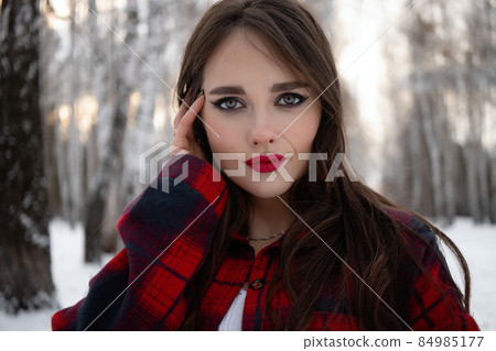 Woman with red lips in winter forest 84985177