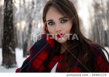 Woman with red lips in winter forest 84985178