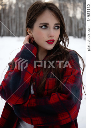 Woman with red lips in winter forest Woman with red lips in winter forest 84985180